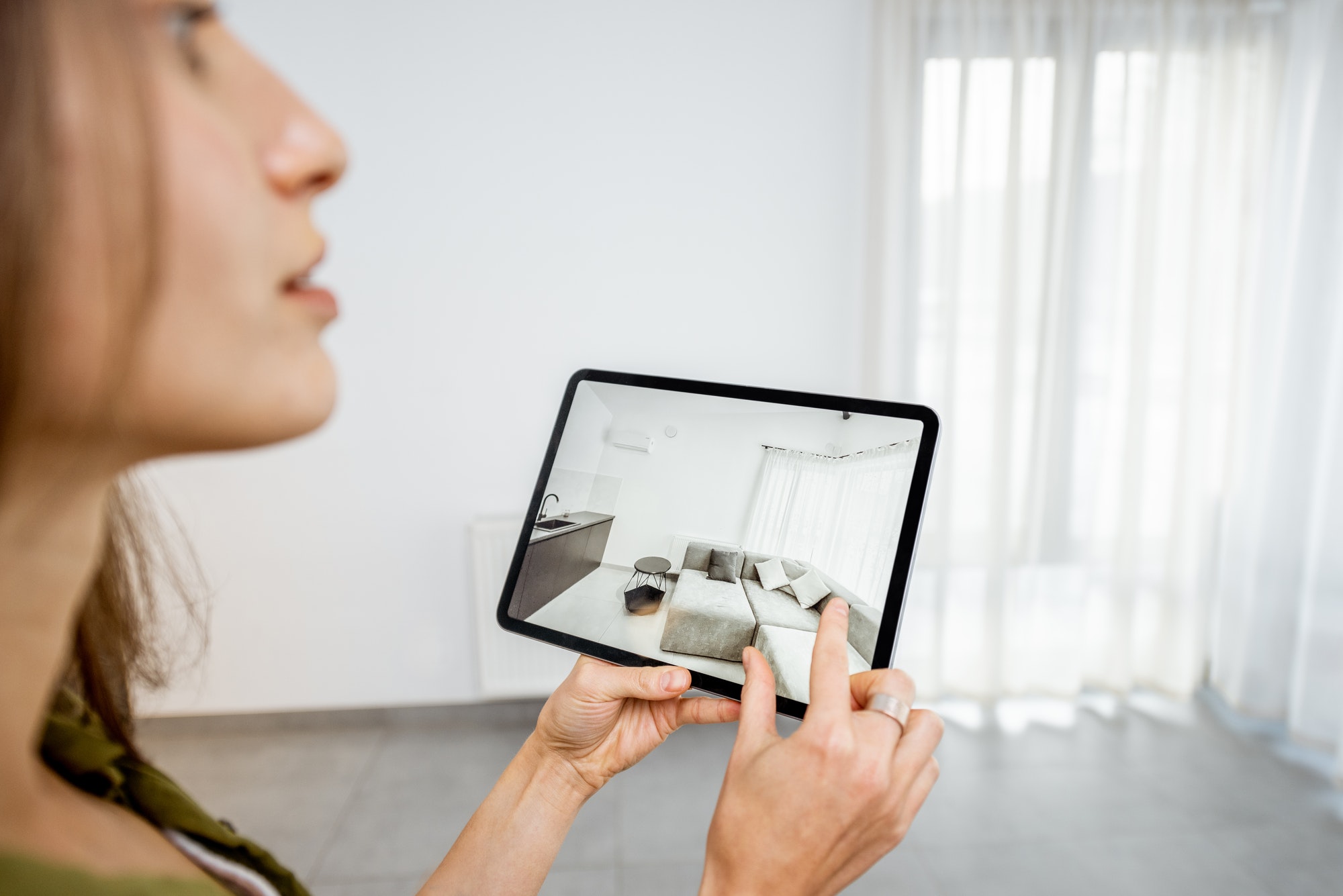 Online shopping trends: woman using augmented reality to design a living room 